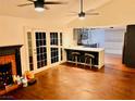 Inviting living room features a brick fireplace, hardwood floors, and glass doors to outdoor area at 3664 Rawhide St, Las Vegas, NV 89120