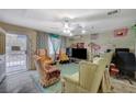 Cozy living room features tile floors, a ceiling fan, and ample seating, perfect for relaxing or entertaining at 405 Longtree Ave, Henderson, NV 89011