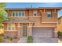 Charming two-story home with neutral paint, stone accents, a two-car garage, and manicured landscaping at 5662 Escamilla Rd, Las Vegas, NV 89135