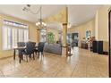 Spacious open-concept living area with tile flooring, bright windows, and decorative archways at 5752 Shermer Ct, Las Vegas, NV 89120