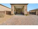 Open three-car garage with brick-paved driveway showing ample storage space at 5860 Noah Springs Ct, Las Vegas, NV 89149