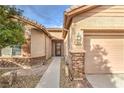 Inviting front entrance with stone accents, leading to a well-maintained home at 6128 Forest Pony Ave, Las Vegas, NV 89122