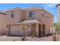 Charming two-story home with a two car garage, desert landscaping, and covered entry at 6221 Blood Lily Ave, Las Vegas, NV 89122