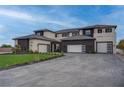 Stunning home featuring a manicured lawn, paved driveway, and three-car garage at 6265 Iron Mountain Rd, Las Vegas, NV 89131
