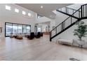 Bright, airy living room with hardwood floors, modern staircase, and large windows at 6265 Iron Mountain Rd, Las Vegas, NV 89131
