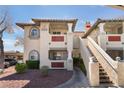 Attractive apartment building with stucco exterior, tile roof, and covered parking at 6808 Elm Creek Dr # 203, Las Vegas, NV 89108