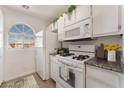 Clean kitchen with white appliances, granite countertops, and natural light at 6808 Elm Creek Dr # 203, Las Vegas, NV 89108