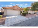 Single-story home featuring a spacious driveway, two-car garage, and low-maintenance desert landscaping at 8113 Dolphin Landing Dr, Las Vegas, NV 89128