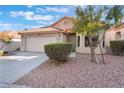 Front exterior view of a charming single-story home showcasing a two-car garage and desert landscaping at 8113 Dolphin Landing Dr, Las Vegas, NV 89128