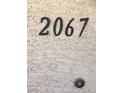 Close-up of the unit's street number '2067' affixed to the exterior wall at 8410 Eldora Ave # 2067, Las Vegas, NV 89117