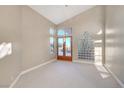Bright bedroom featuring vaulted ceilings and a walk-out to a beautiful backyard at 8470 S Pioneer Way, Las Vegas, NV 89113