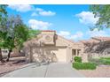 Charming single-story home featuring a well-manicured front yard and a two-car garage at 8620 Prairie Hill Dr, Las Vegas, NV 89134