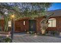 Inviting entryway featuring a brick facade, double doors, and desert landscaping at 9 Quail Run Rd, Henderson, NV 89014