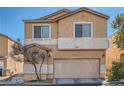 Two-story home with a tan exterior, featuring an attached garage and well-maintained landscaping at 9465 Milkweed Canyon Ave, Las Vegas, NV 89166
