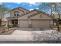 Attractive two-story house with a convenient two-car garage and a welcoming front yard at 10385 Grassyrock Ct, Las Vegas, NV 89129