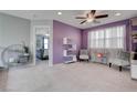 Stylized bedroom with purple accent wall, complementary decor, and adjoined room at 1141 Cactus Rock St, Henderson, NV 89011
