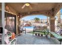 Relaxing covered patio area overlooking a sparkling pool and backyard oasis at 1229 Swanbrooke Dr, Las Vegas, NV 89144
