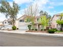 Charming two-story home boasts a well-manicured lawn, mature trees, and a spacious two-car garage at 1307 Bayleaf Terrace Ave, Henderson, NV 89014