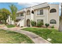 Attractive two-story condo featuring well-maintained lawn, walkway, and classic desert landscaping at 1404 Santa Margarita St # D, Las Vegas, NV 89146