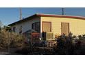 Side view of a quaint single-story home with weathered siding and foliage at 203 W Pacific Ave, Henderson, NV 89015
