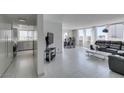 View of the home's bright open floor plan featuring tile flooring, a gray sofa, and sightlines to the kitchen and dining area at 205 E Harmon Ave # 511, Las Vegas, NV 89169