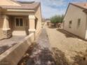 Exterior view of a walkway between two single story homes with desert landscaping at 2704 Willow Wren Dr, North Las Vegas, NV 89084
