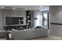 Modern living room with comfortable seating, built-in shelving, and stylish decor at 2881 Red Rock Dr, Pahrump, NV 89048
