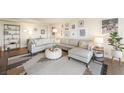 Bright living room featuring a large sectional sofa, modern decor, and hardwood floors, creating a welcoming space at 3111 Bel Air Dr # 10F, Las Vegas, NV 89109