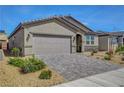 A well-maintained single-story home with a two-car garage and appealing desert landscaping at 378 Hellebores Ave, North Las Vegas, NV 89084