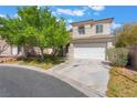 Two-story home showcasing mature trees, a two-car garage, and a well-maintained driveway at 5100 Amethyst Creek Ct, Las Vegas, NV 89131