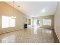 Spacious living room with tile flooring, a fireplace, and lots of natural light from the sliding glass door at 5127 Fiji Island Ct, North Las Vegas, NV 89031