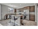 Modern kitchen with granite countertops, stainless steel appliances, and a center island with barstool seating at 5232 Mountain Garland Ln, North Las Vegas, NV 89081
