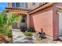 Charming front yard with desert landscaping and a walkway leading to the front door at 5513 Nickel Ridge Way, Las Vegas, NV 89122