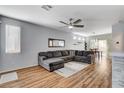 Open-concept living area with wood flooring, a large sectional sofa, and ample natural light at 5513 Nickel Ridge Way, Las Vegas, NV 89122