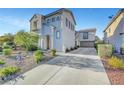 Two-story home boasts a landscaped front yard and a spacious driveway leading to a two-car garage at 5712 Almocita Ct, Las Vegas, NV 89141