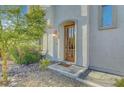 Home's front door boasts a charming stone entrance and decorative shrubs at 5712 Almocita Ct, Las Vegas, NV 89141