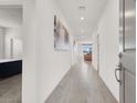 Bright hallway features stylish wood floors and modern recessed lighting at 6261 Lamont Hills Ave, Las Vegas, NV 89139