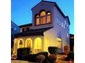 Inviting exterior displaying arched doorway, well-placed windows, and manicured bushes at 6647 Rego Park Ct, Las Vegas, NV 89166