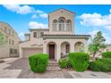 Charming home featuring arched entryway, well-manicured landscaping, and a two-car garage at 6647 Rego Park Ct, Las Vegas, NV 89166