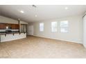 Spacious living room with tile floors, bright windows, and open layout to the kitchen area at 6856 Council Heights Way, Las Vegas, NV 89142
