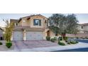 Attractive two-story home with a three-car garage, complemented by well-maintained landscaping at 8136 Canyon Grassland St, Las Vegas, NV 89166