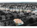 Aerial view of a waterfront community with a highlighted home with a pool and terra cotta roof at 8140 Bay Harbor Dr, Las Vegas, NV 89128