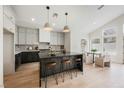 Modern kitchen features stainless steel appliances, an island with bar stools, and an adjacent breakfast nook at 8140 Bay Harbor Dr, Las Vegas, NV 89128