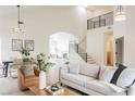 Bright open-concept living room with modern furnishings, high ceilings, and staircase to the upper level at 8140 Bay Harbor Dr, Las Vegas, NV 89128