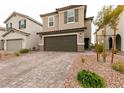Well-maintained home with a two-car garage, desert landscaping, and a welcoming covered entrance at 9526 Granville Bridge St, Las Vegas, NV 89139