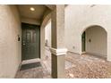 Inviting front entryway with a stylish door, stone accents, and a well-lit, covered porch at 9526 Granville Bridge St, Las Vegas, NV 89139