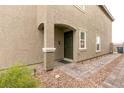 Attractive home exterior with stone accents, a covered entryway, and tidy landscaping along a paved walkway at 9526 Granville Bridge St, Las Vegas, NV 89139
