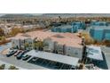 Wide aerial view of community featuring condos with red tile roofs, assigned covered parking, and desert landscaping at 10001 Peace Way # 2269, Las Vegas, NV 89147