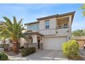 Inviting two-story home showcasing a desert landscape, balcony, and welcoming curb appeal at 10505 Howling Coyote Ave, Las Vegas, NV 89135