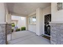 Welcoming front porch featuring stone accents and a stylish security door at 10505 Howling Coyote Ave, Las Vegas, NV 89135